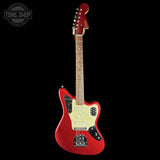 A red electric guitar with a gold glitter pickguard and black hardware, shown against a solid black background with a Tone Shop watermark in the top-left corner.