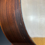Close-up of a guitar's wooden neck and metal binding