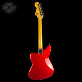 A red electric guitar shown from the back against a solid black background, with a yellow neck and headstock. A circular 'TONE SHOP' watermark is visible in the top-left corner.