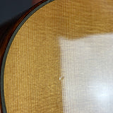 Close-up of a guitar's soundhole with a textured finish