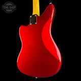 Close-up of the rear body of a red electric guitar with a yellow neck, shown against a solid black background. A Tone Shop watermark is visible in the top-left corner.