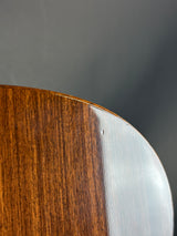 Close-up of a wooden surface with a metallic edge on a dark background