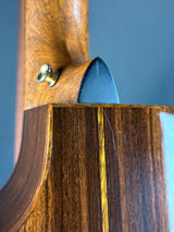 Close-up of a wooden object with a metallic tip on a blue background