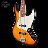 A classic Fender Stratocaster electric bass guitar with a sunburst finish, featuring a white pickguard, black control plate, and chrome hardware, shown against a solid black background.