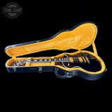 Guitar in an open case with 'Tone Shop' logo in the corner