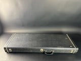 Black leather briefcase on a dark surface with a plain background