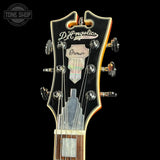 Guitar headstock with D'Angelico branding on a black background