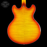 Back view of a sunburst electric guitar with 'Tone Shop' logo in the corner.