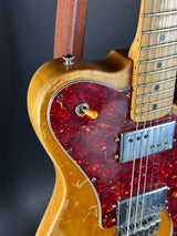 Close-up of a guitar with a red flame pattern on a black background