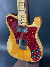 Electric guitar with a red flame pattern on a dark background