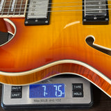 Electric guitar on a digital scale displaying weight