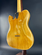 Close-up of a wooden electric guitar on a dark background