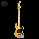 A natural wood four-string bass guitar with a black pickguard and hardware, shown vertically against a solid black background. A Tone Shop watermark is visible in the top-left corner.
