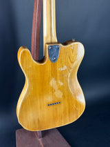 Close-up of a guitar body with a dark background