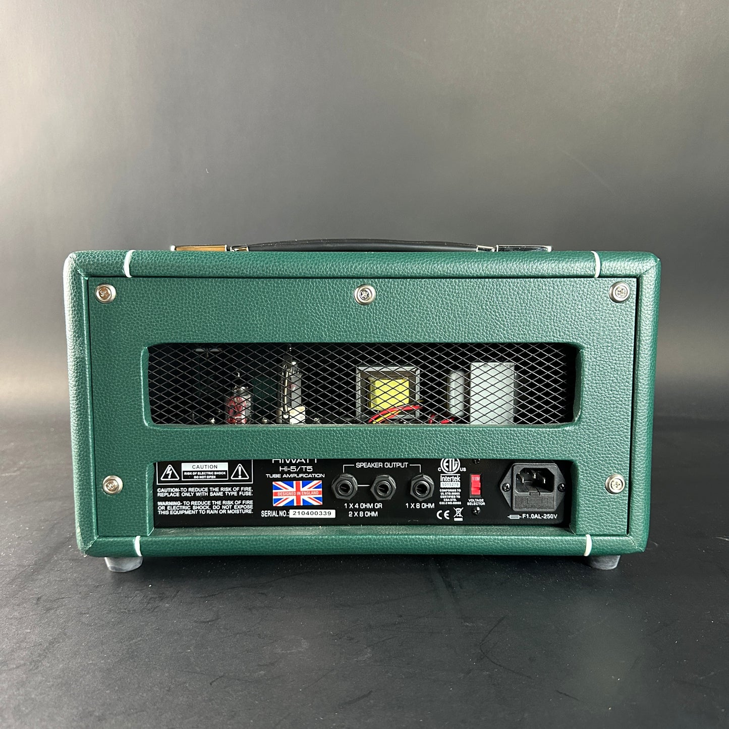 Green guitar amplifier on a gray background