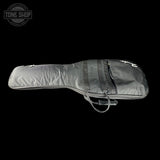 A gray padded instrument gig bag with a white script logo on the front, shown against a solid black background. A Tone Shop watermark is visible in the top-left corner.