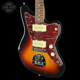 A double-cutaway electric guitar with a sunburst finish, featuring a red and black tortoiseshell pickguard, cream humbucker pickups, and a black body, shown against a black background with a Tone Shop watermark in the top left corner.