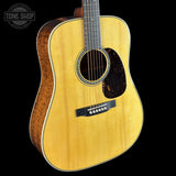 Acoustic guitar with a visible brand logo in the corner
