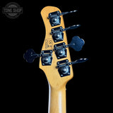 Close-up of a guitar headstock with tuning pegs on a black background, featuring the Tone Shop logo.