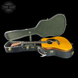 Open guitar case with a wooden guitar inside, branded 'Tone Shop'.