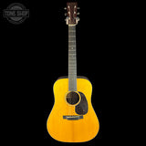 Acoustic guitar with a visible brand logo on a black background