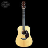 Acoustic guitar with a visible brand logo on a white background