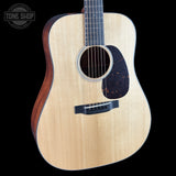 Acoustic guitar with a visible brand logo in the corner