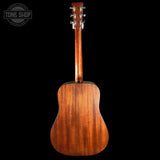 Back view of a wooden acoustic guitar on a black background with 'Tone Shop' logo.