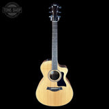 Taylor 112ce Studio Prototype full front photo over a black background.