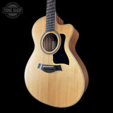 Taylor 112ce Studio Prototype Acoustic guitar with a visible brand logo on a black background