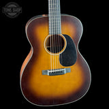Acoustic guitar with a sunburst finish on a black background, featuring the Tone Shop logo.