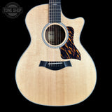 Taylor 314ce Prototype Next Generation Acoustic guitar with flame maple top on a black background, featuring 'Tone Shop' logo.