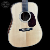 Acoustic guitar with a visible brand logo in the corner