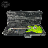 A green flamed maple electric guitar inside an open black hard case with a gray velvet-lined interior, shown against a black background. A Tone Shop watermark is visible in the top-left corner.