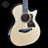 Taylor Builder's Edition 514ce Prototype Acoustic guitar with flame pattern on a black background, featuring the Tone Shop logo.