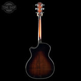 Back view of a Taylor Builder's Edition 514ce Prototype dark wood finish on a black background, featuring the Tone Shop logo.
