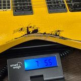 Jackson Custom Shop USA Special Edition Soloist Taxi Cab Yellow Nitro Tour Relic on scale displaying weight.