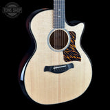 Taylor Builder's Edition 514ce Prototype Acoustic guitar with a black and orange pattern on the body against a black background, featuring the Tone Shop logo.