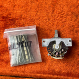 Mechanical component and clear bag with cylindrical items on an orange surface