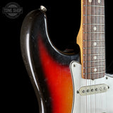 Close-up of a electric guitar with a visible brand logo in the corner.