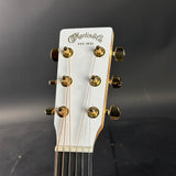 Close-up of a guitar headstock with 'Martin & Co' branding on a dark background