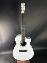 White acoustic guitar on a dark gray background