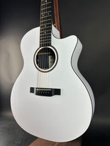 White acoustic guitar on a dark background