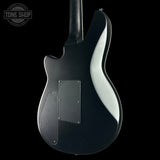 Black electric guitar on a black background with 'Tone Shop' logo.