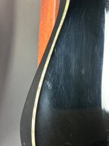 Close-up of a guitar's soundhole with visible wear and tear.