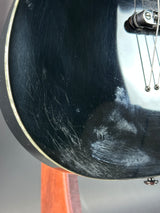 Close-up of a guitar's soundhole with visible wear and tear.