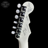Guitar headstock with tuning pegs on a black background, featuring the 'Tone Shop' logo.
