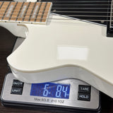 White electric guitar on a digital scale displaying weight