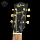 Gibson guitar headstock with brand name on a black background