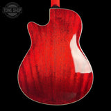 The back of a double-cutaway electric guitar with a glossy red cherry wood finish, shown against a solid black background. A Tone Shop watermark is visible in the top-left corner.